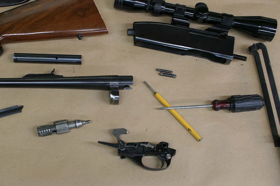Gunsmith repairing a firearm at Ron’s Gun Shop